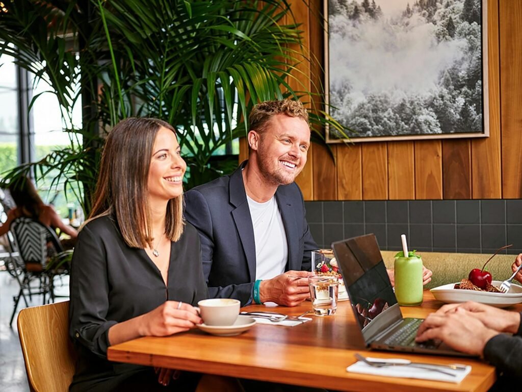 Melbourne mortgage broker comparing home loan refinancing options on a laptop with a client