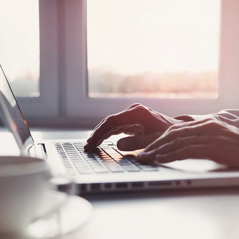 Homeowner comparing current home loan interest rates against refinancing options on a laptop at home